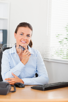 Thinking businesswoman behind her desk