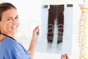 Brunette smiling doctor with a stethoscope and a x-ray