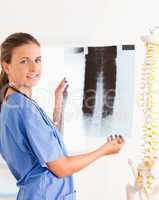 Smiling brunette doctor with a stethoscope and a x-ray