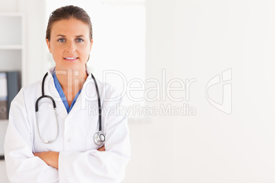 Charming doctor having a stethoscope around her neck looking int