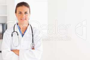 Charming doctor having a stethoscope around her neck looking int