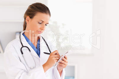 Concentrated doctor writing something down