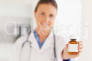 Cute doctor handing over some pills