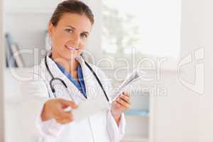 Charming brunette doctor handing out a prescription
