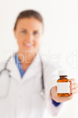 Close up of a cute doctor handing over some pills