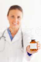 Close up of a cute doctor handing over some pills