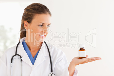 Good looking doctor looking at some pills