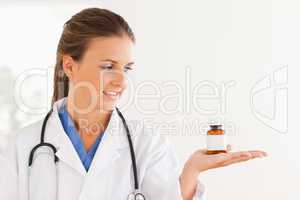 Good looking doctor looking at some pills