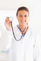 smiling doctor showing stethoscope looking into the camera