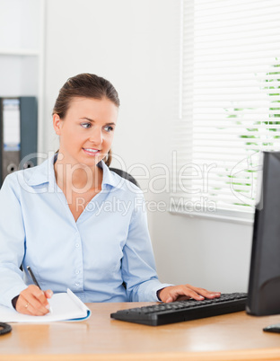 good looking brunette businesswoman sitting behind her desk