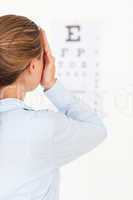 Brunette woman looking at an eye test