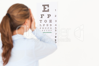 Beautiful brunette woman making an eye test