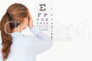 Beautiful brunette woman making an eye test