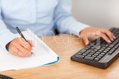 gorgeous businesswoman typing and writing