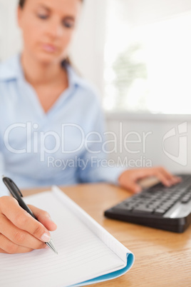 Beautiful working businesswoman sitting behind her desk