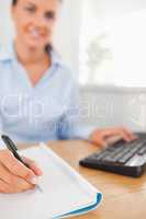 Brunette working businesswoman sitting behind her desk