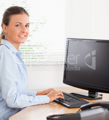 Businesswoman typing at workplace