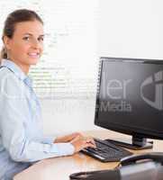 Businesswoman typing at workplace