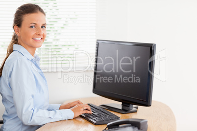 Woman in office looking while typing