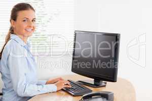 Woman in office looking while typing