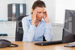 Stressed woman sitting in office
