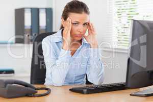 Stressed woman looking at camera in office