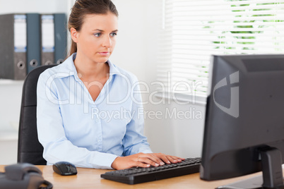 Businesswoman is typing in office