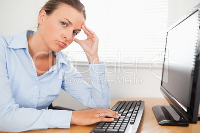 Businesswoman looking into camera at workplace