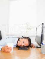 Secretary with headset sleeps in office