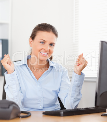 Happy businesswoman sitting in office