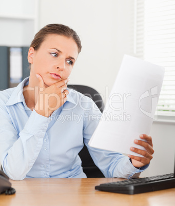 Portrait of a gorgeous businesswoman reading a paper