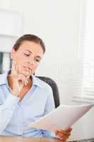 Portrait of a gorgeous businesswoman concentrating on a paper