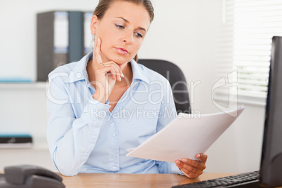 Portrait of a gorgeous businesswoman concentrating on a paper