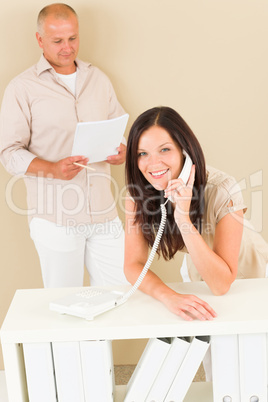 Casual businesswoman calling phone man colleague