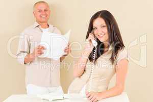 Casual businesswoman calling phone man colleague