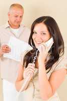 Casual businesswoman calling phone man colleague