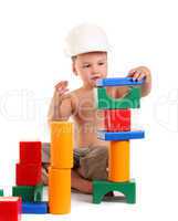 Little boy builds a house of toys