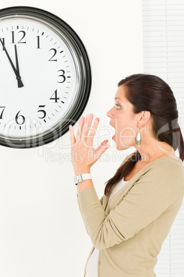 Surprised punctual businesswoman looking at clock