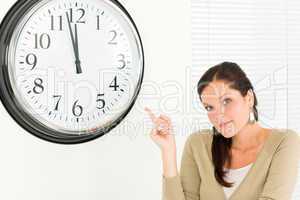 Punctual businesswoman attractive point at clock