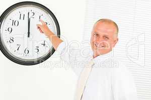 Punctual businessman mature point at clock
