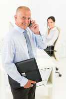 Mature businessman calling hold briefcase