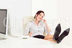 Legs on table relax smiling businesswoman calling