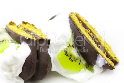 pieces of cake with cream and kiwi
