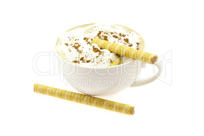 a cup of cappuccino and wafer rolls isolated on white