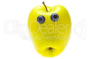 green apple with eyes of blueberries isolated on white