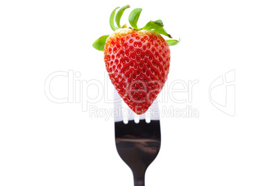 Strawberry on fork isolated on white