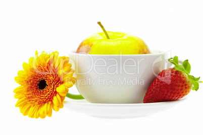 apple in a cup, strawberry and flower isolated on white