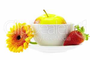 apple in a cup, strawberry and flower isolated on white