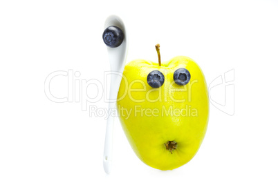 apple with eyes of blueberries isolated on white