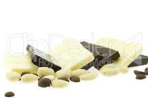 Tiles of dark and white chocolate isolated on white